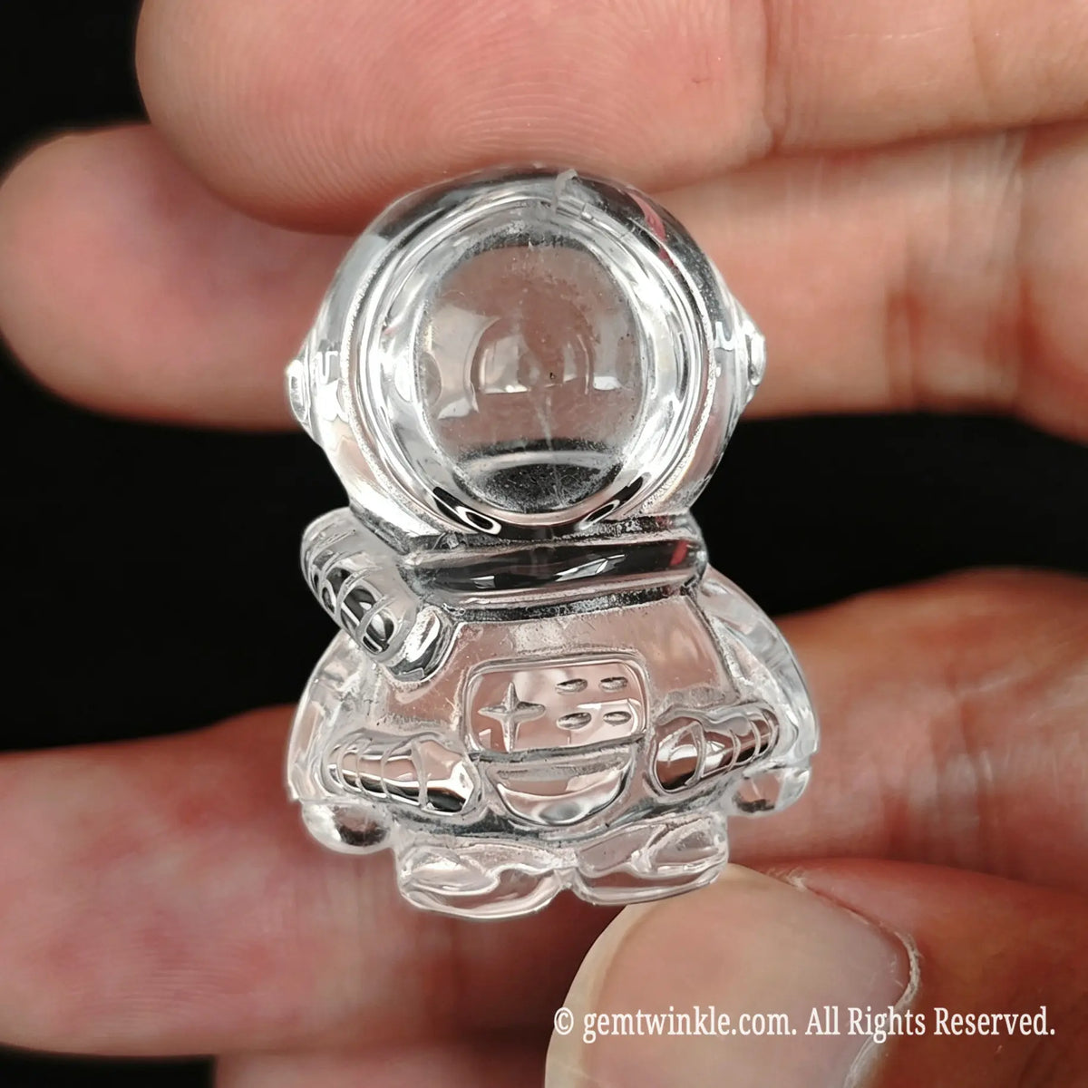 Close up preview of 3cm clear quartz astronaut figurine showing smooth polished finish and clarity