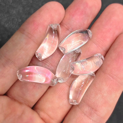 rock crystal curved tube beads showing icy water clarity placed on hand