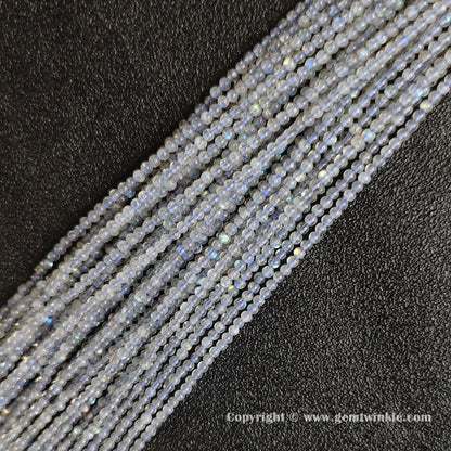 Flatlay alignment of fine grey blue moonstone micro gemstone strands highlighting petite bead uniform drilling