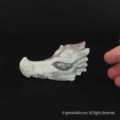 Side profile of a flower tourmaline dragon head carving demonstrating detailed mineral features