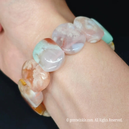 Flower agate smooth tile bead stretch bracelet styled on wrist displaying comfortable fit and pastel chalcedony colors