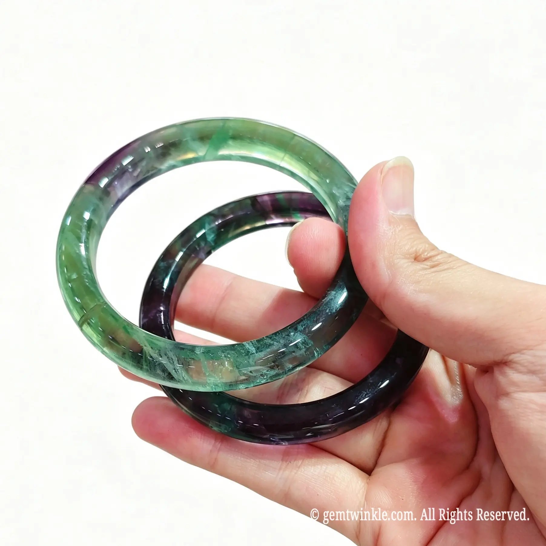 Hand holding fluorite mineral gemstone band ready for live sale inventory and boutique reseller supply