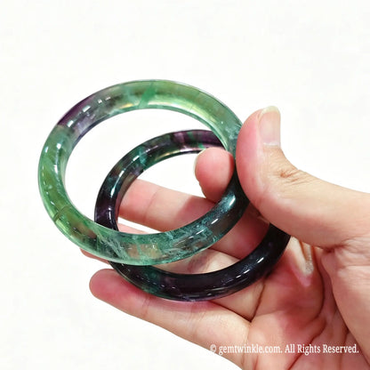 Hand holding fluorite mineral gemstone band ready for live sale inventory and boutique reseller supply