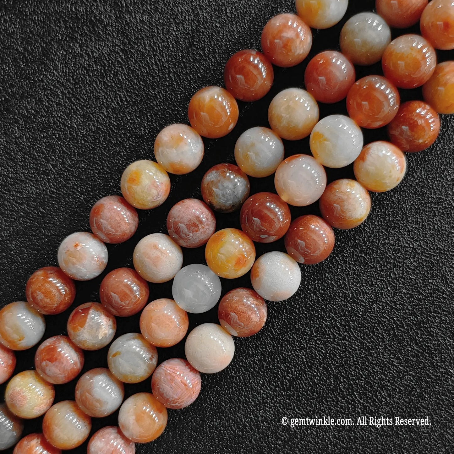 Close up of blooming chrysanthemum patterns on fossilized coral jade round crystal beads
