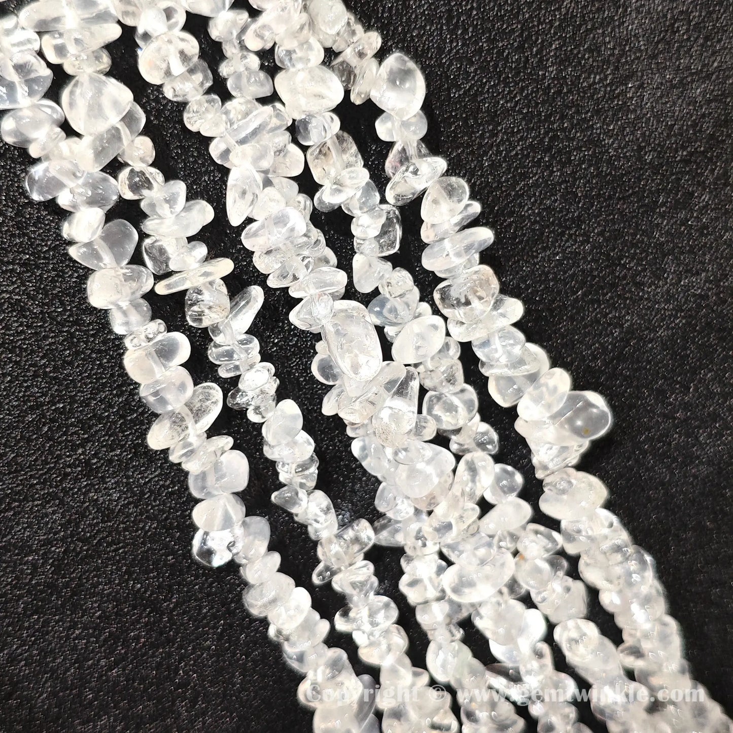 Long strand layout of frosted white cloudy quartz chip beads for jewelry crafting