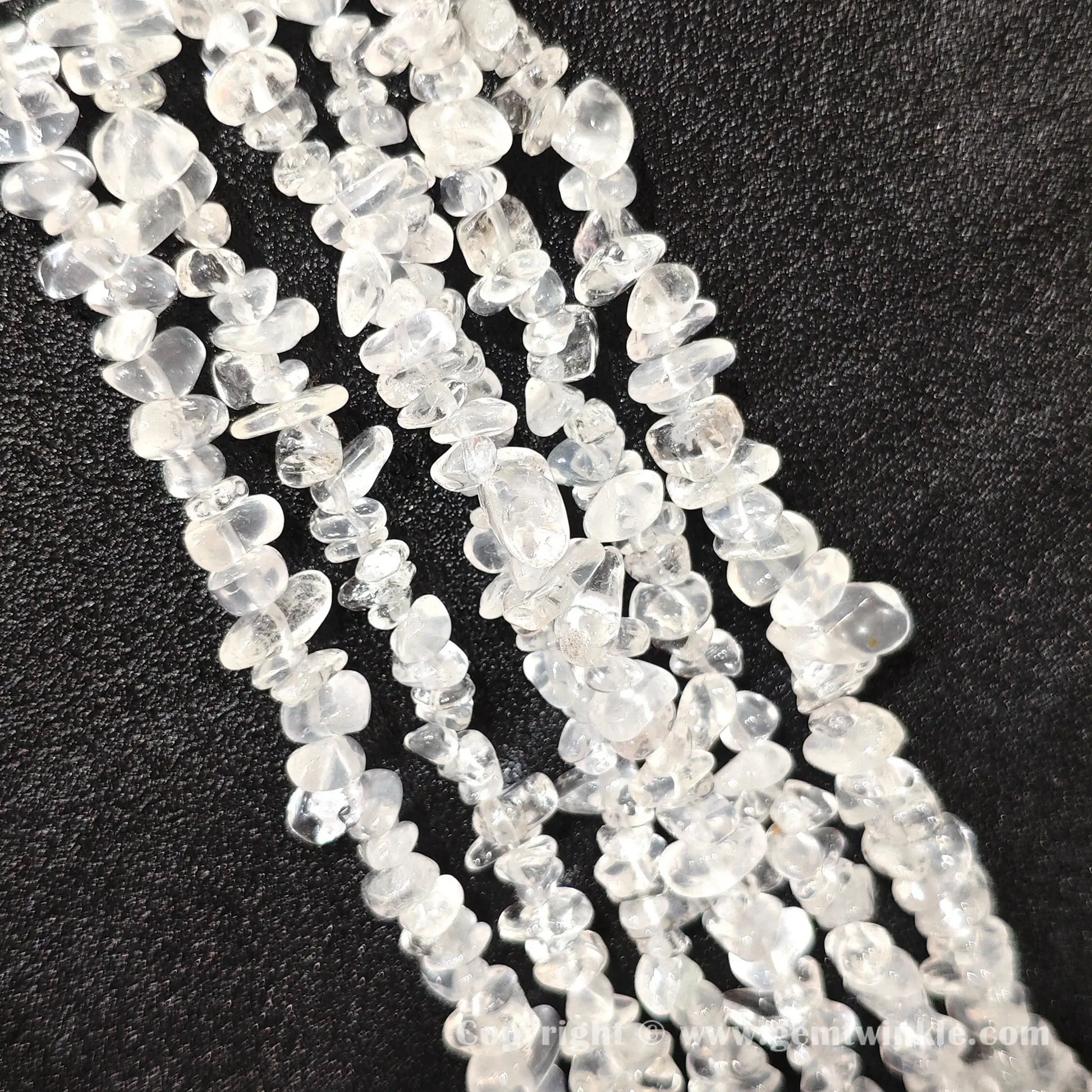Long strand layout of frosted white cloudy quartz chip beads for jewelry crafting