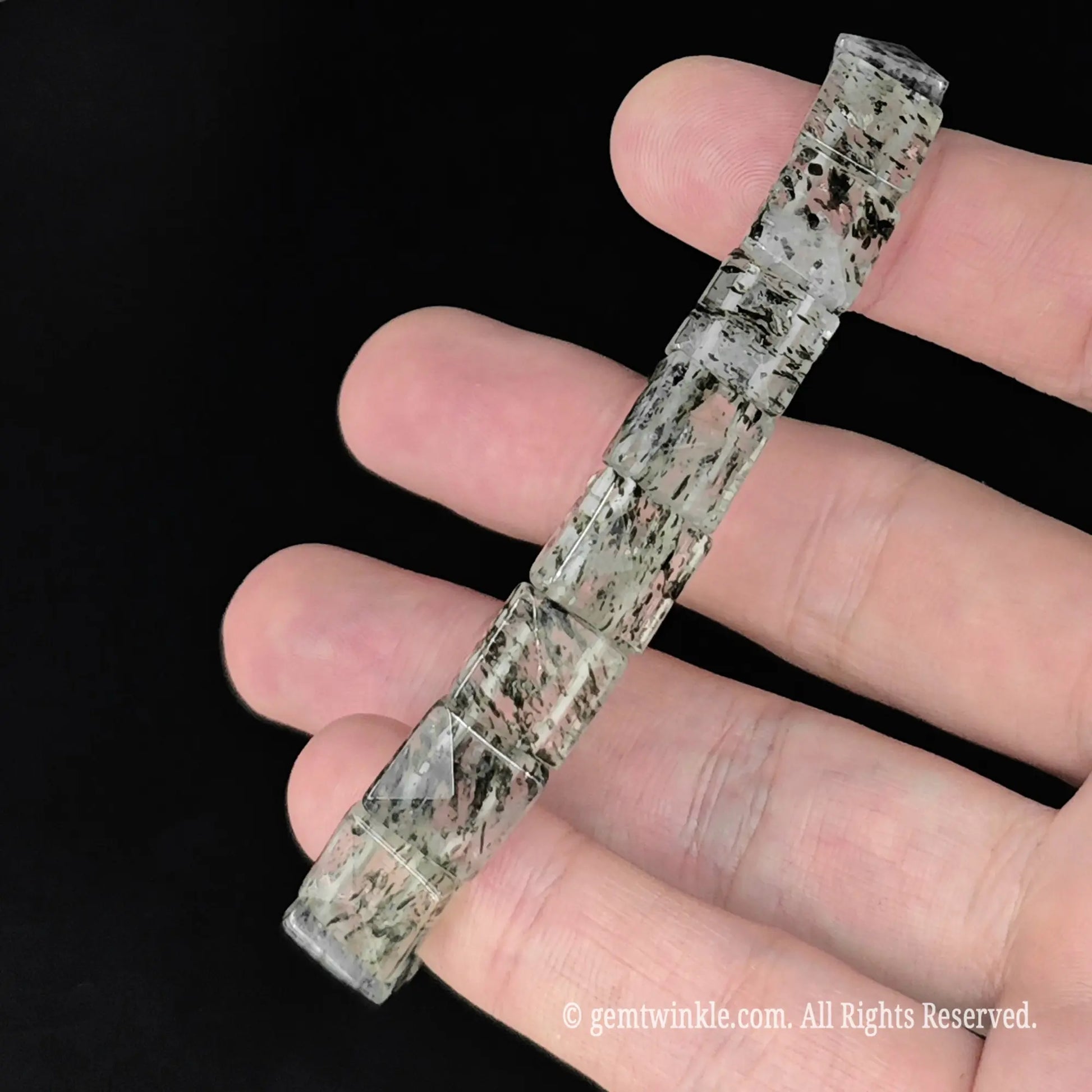 straight top view of 10mm green mica inclusion clear quartz pyramid faceted bead bracelet