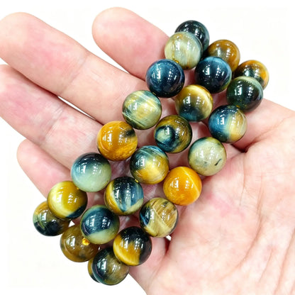 Galaxy tiger eye bracelet showing polished blue and golden yellow chatoyant beads on hand