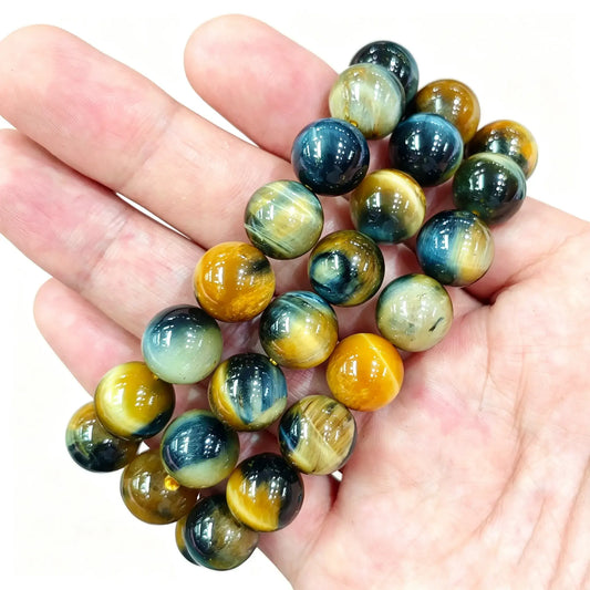 Galaxy tiger eye bracelet showing polished blue and golden yellow chatoyant beads on hand