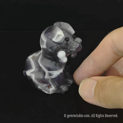 Angled side view of the chevron amethyst puppy totem showing intense purple quartz bands and glossy geometric contours