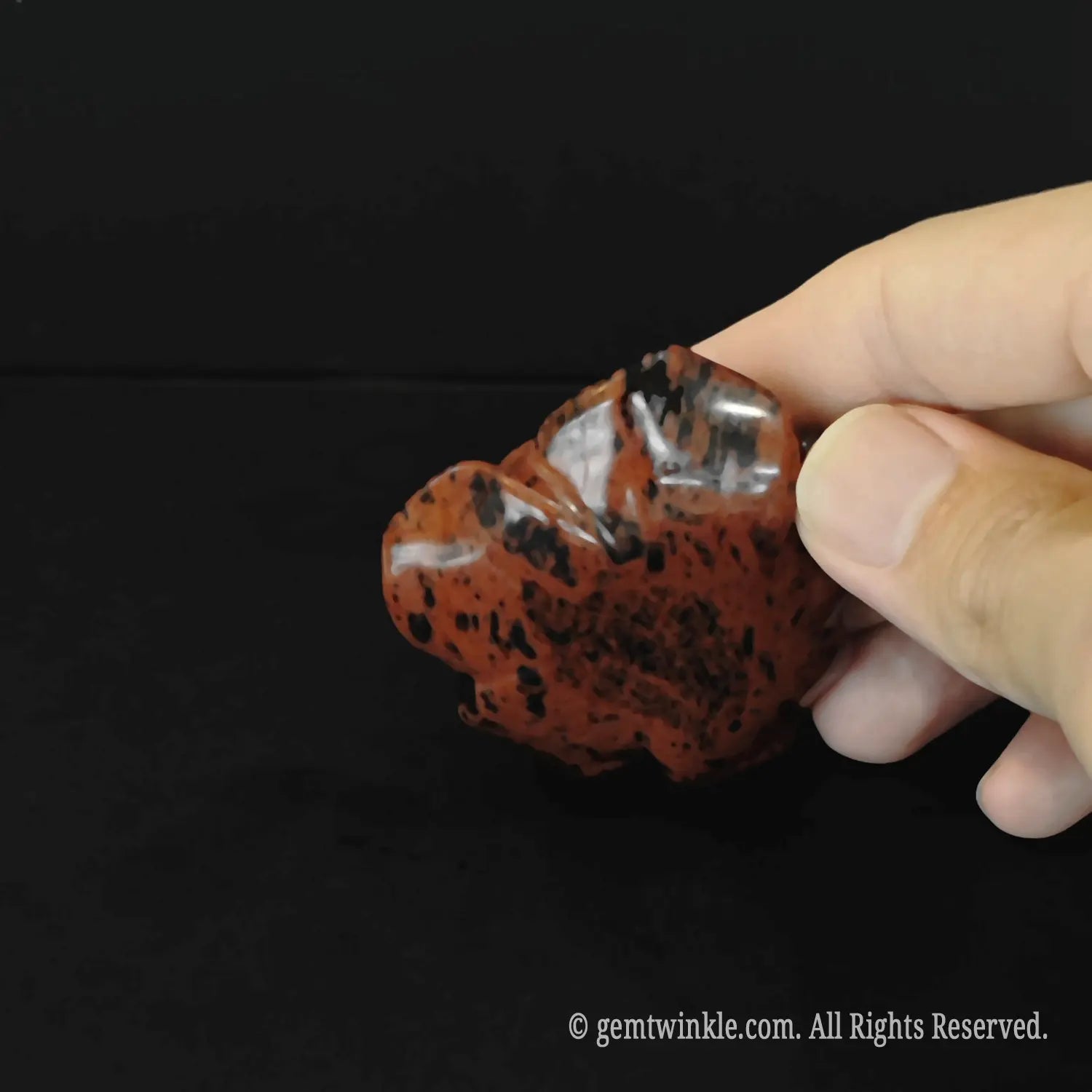 Side view of natural mahogany obsidian rose flower carving showing detailed organic petal layers and sculpture depth