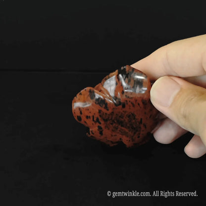 Side view of natural mahogany obsidian rose flower carving showing detailed organic petal layers and sculpture depth