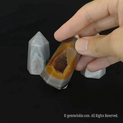 Detailed top angle view of a 5cm carnelian orange geode tower highlighting the deep micro crystalline pocket