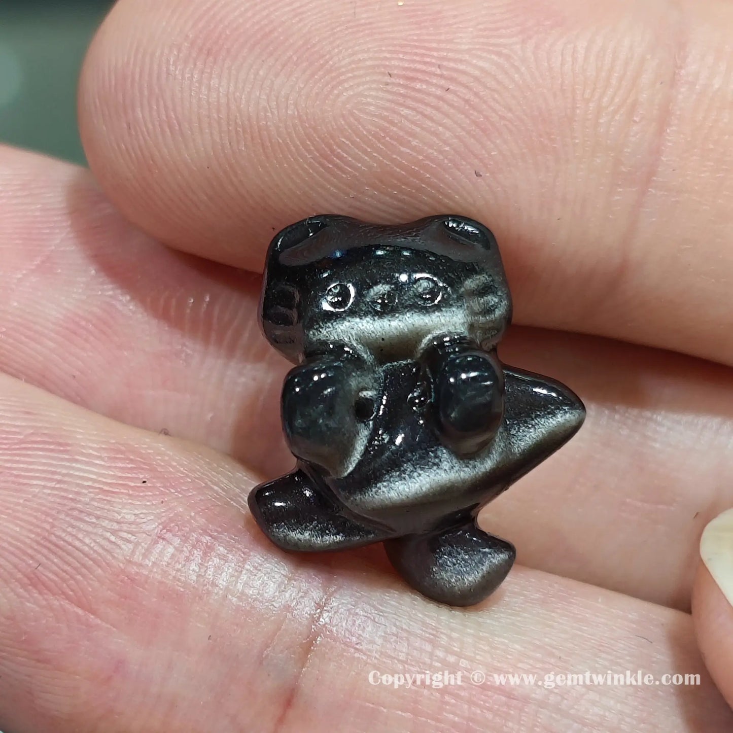 Front view of genuine silver sheen obsidian hugging cat charm bead showing size proportions and drill hole position on hand