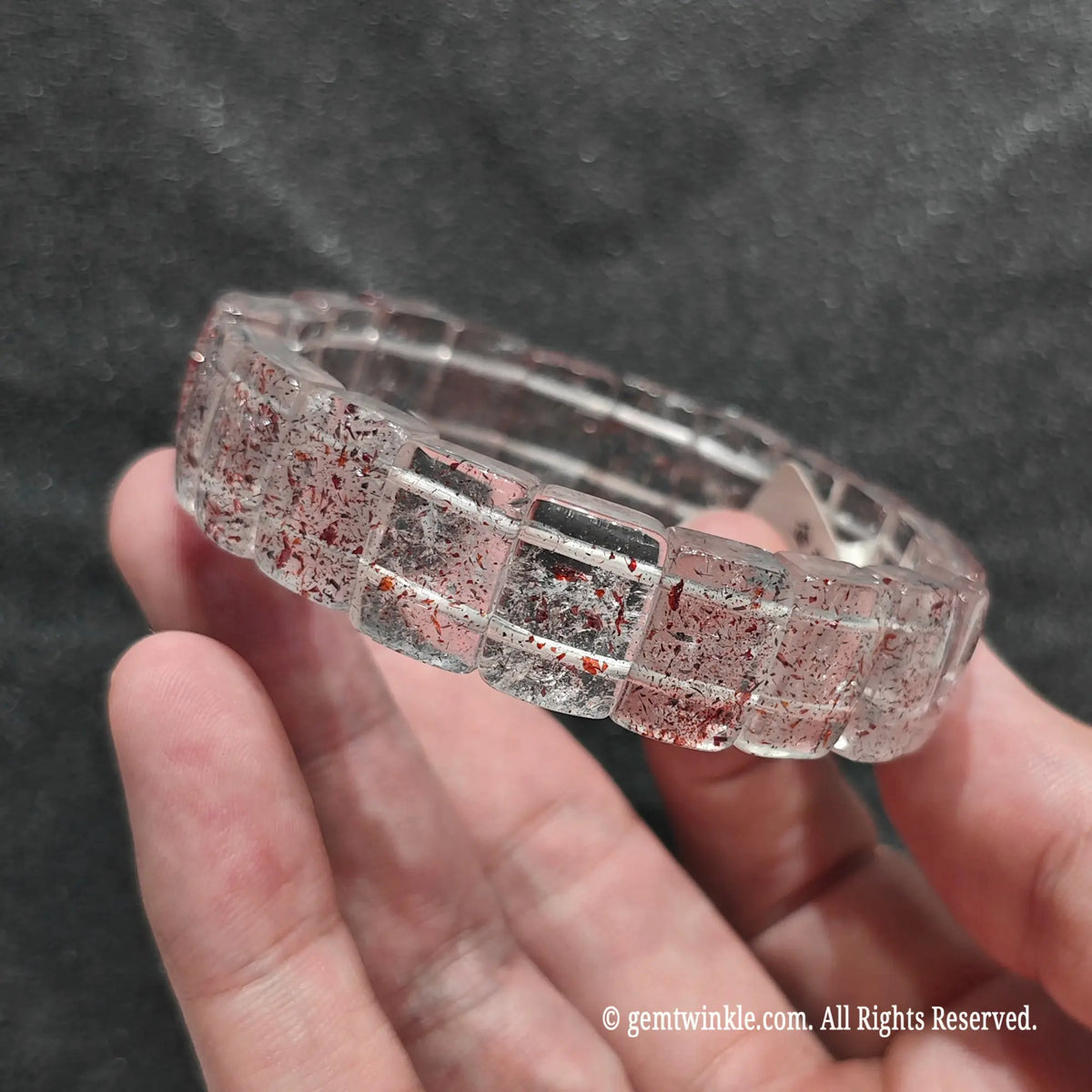 Side angle view of a genuine strawberry quartz bar cut band displaying smooth rectangular polished plate beads