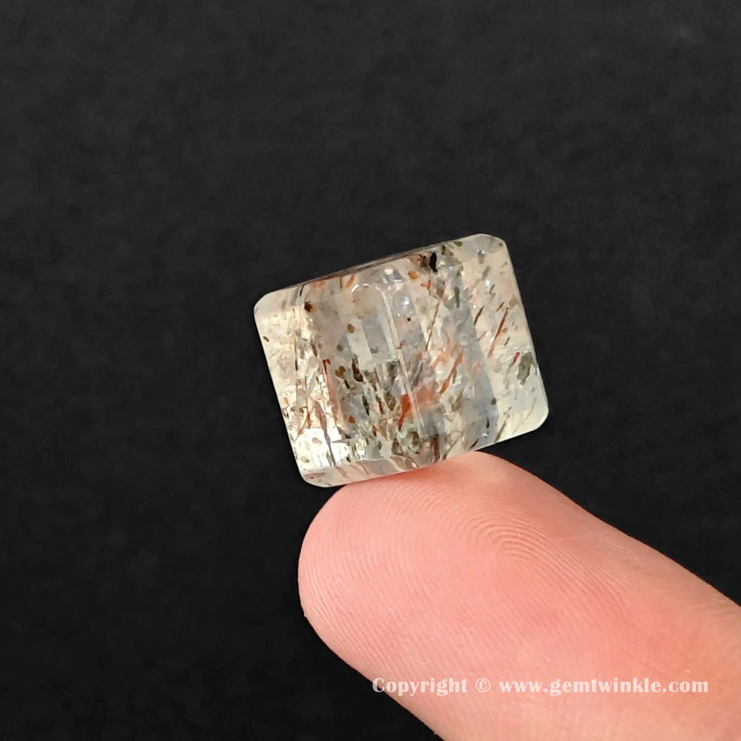 Side view of geometric black gold rutilated quartz cube bead highlighting flat polished edges