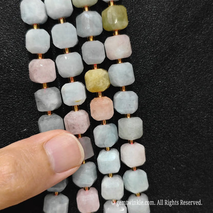 Angled presentation of morganite strands showing their smooth polished finish and clean drill holes