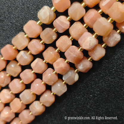 Angled view of polished sunstone square beads highlighting clean center drill holes