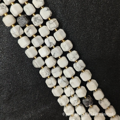 Angled view of polished white turquoise square beads highlighting clean center drill holes
