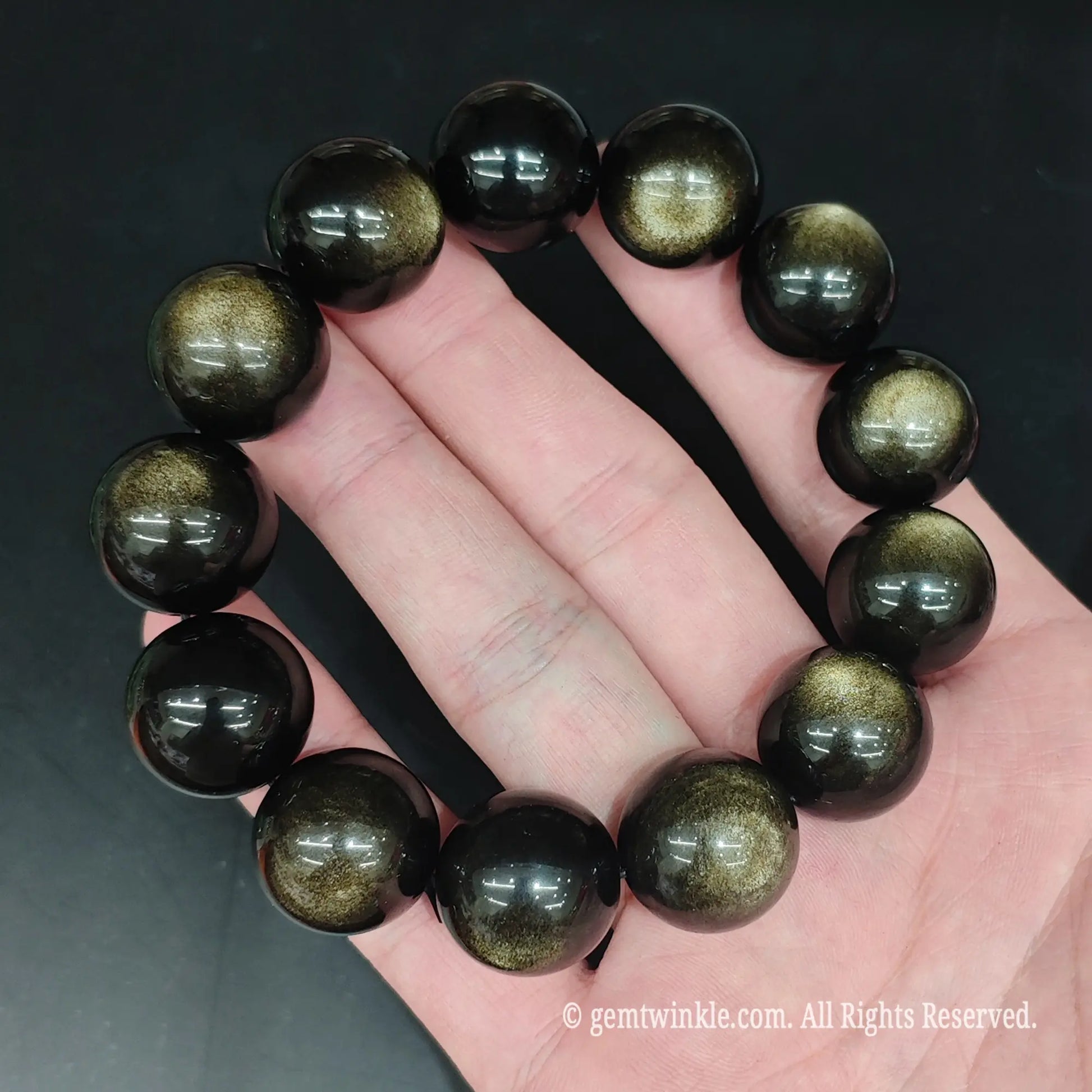 Glossy black gold sheen obsidian bead bracelet top view showing uniform round bead alignment