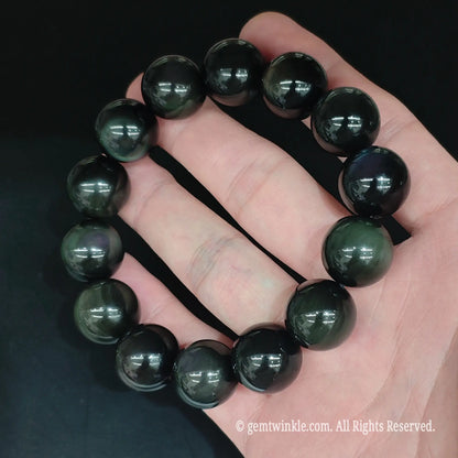 Glossy black rainbow eye obsidian bead bracelet top view showing uniform round bead alignment and mirror polish