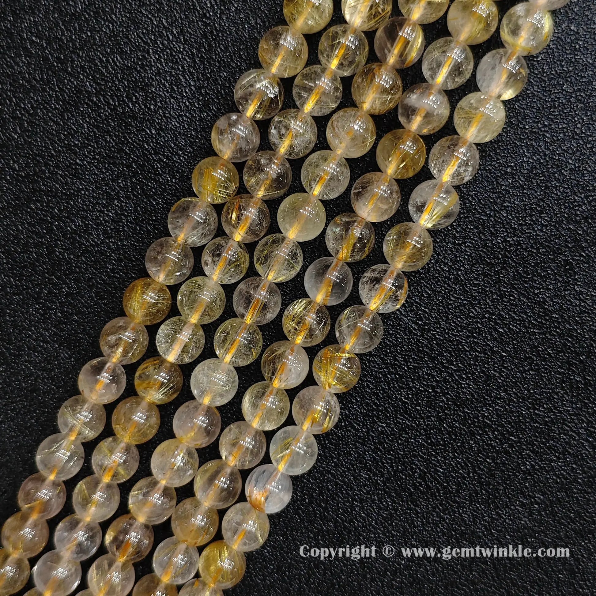 Four strands of un-dyed genuine 8mm gold rutilated quartz crystal beads displaying clear quartz structures from factory supplier