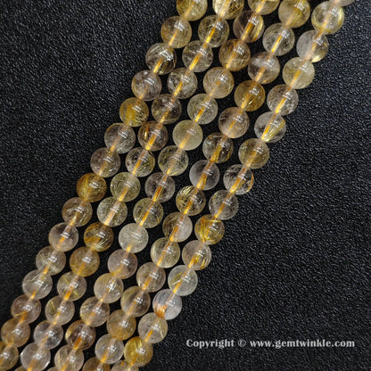Four strands of un-dyed genuine 8mm gold rutilated quartz crystal beads displaying clear quartz structures from factory supplier