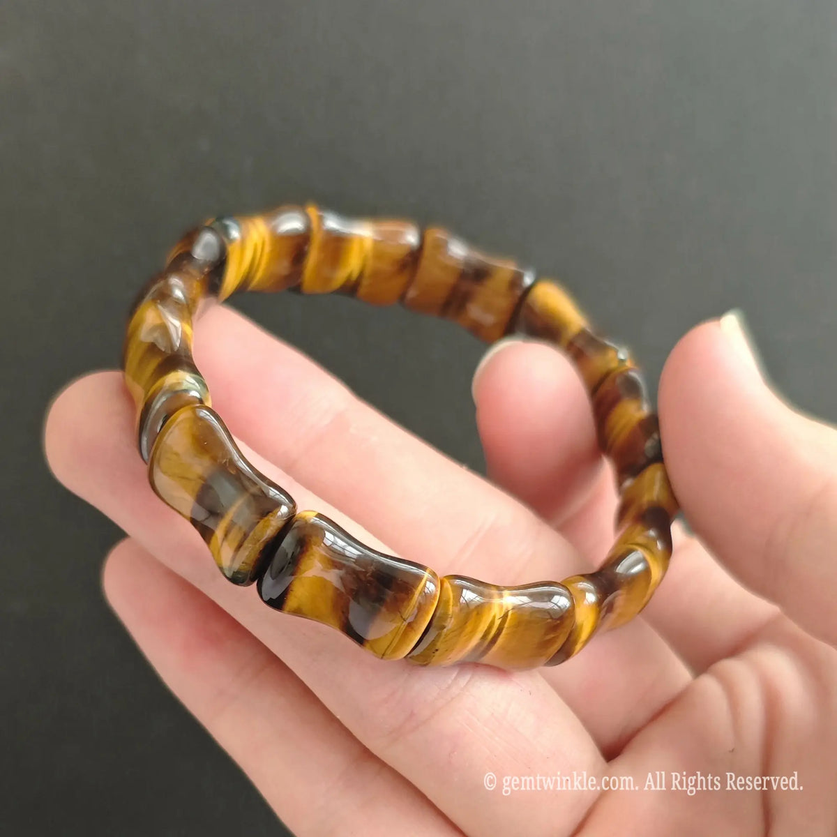 Side profile of natural Tiger Eye bamboo bead bracelet showing 16mm tube proportions and rich mineral depth