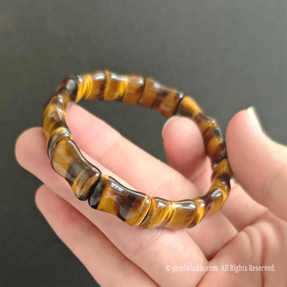 Side profile of natural Tiger Eye bamboo bead bracelet showing 16mm tube proportions and rich mineral depth
