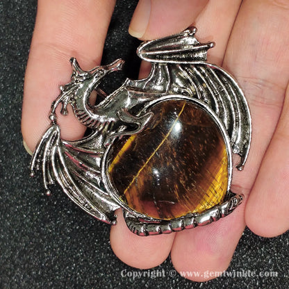 Hand holding 5cm dragon heart tiger eye pendant showing silky chatoyance