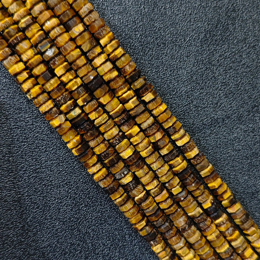 Macro closeup of natural golden tiger eye faceted rondelle beads 6x3mm showing chatoyant silk shine