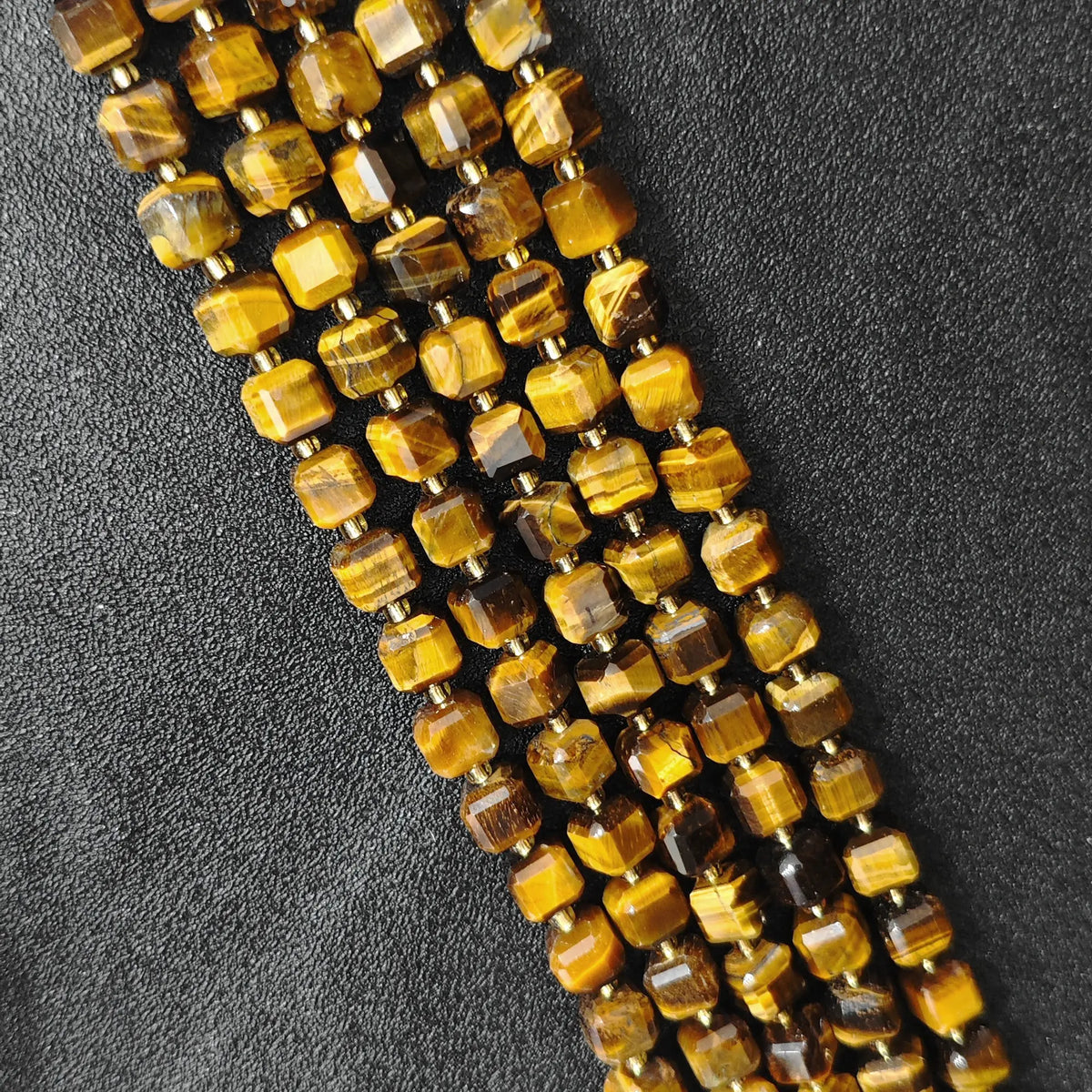 Full strands of natural golden tiger eye square block beads featuring silky chatoyant bands for wholesale buyers