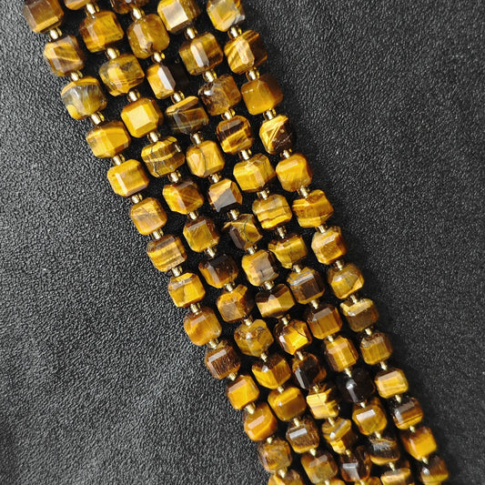 Full strands of natural golden tiger eye square block beads featuring silky chatoyant bands for wholesale buyers