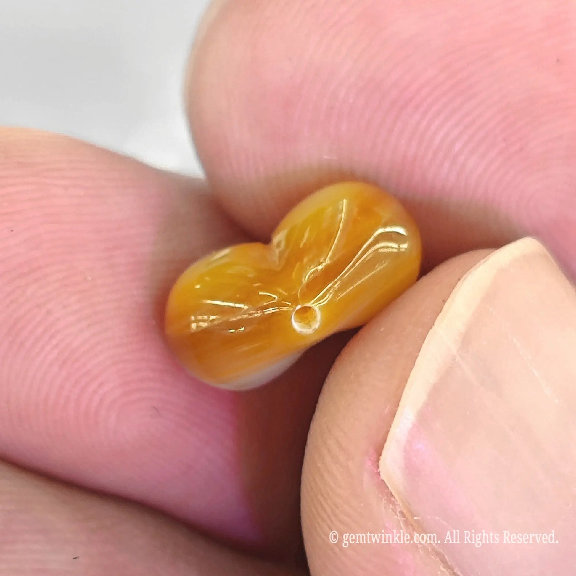 Golden MOP puffy heart bead top angle view showing vertical top to bottom straight drill hole