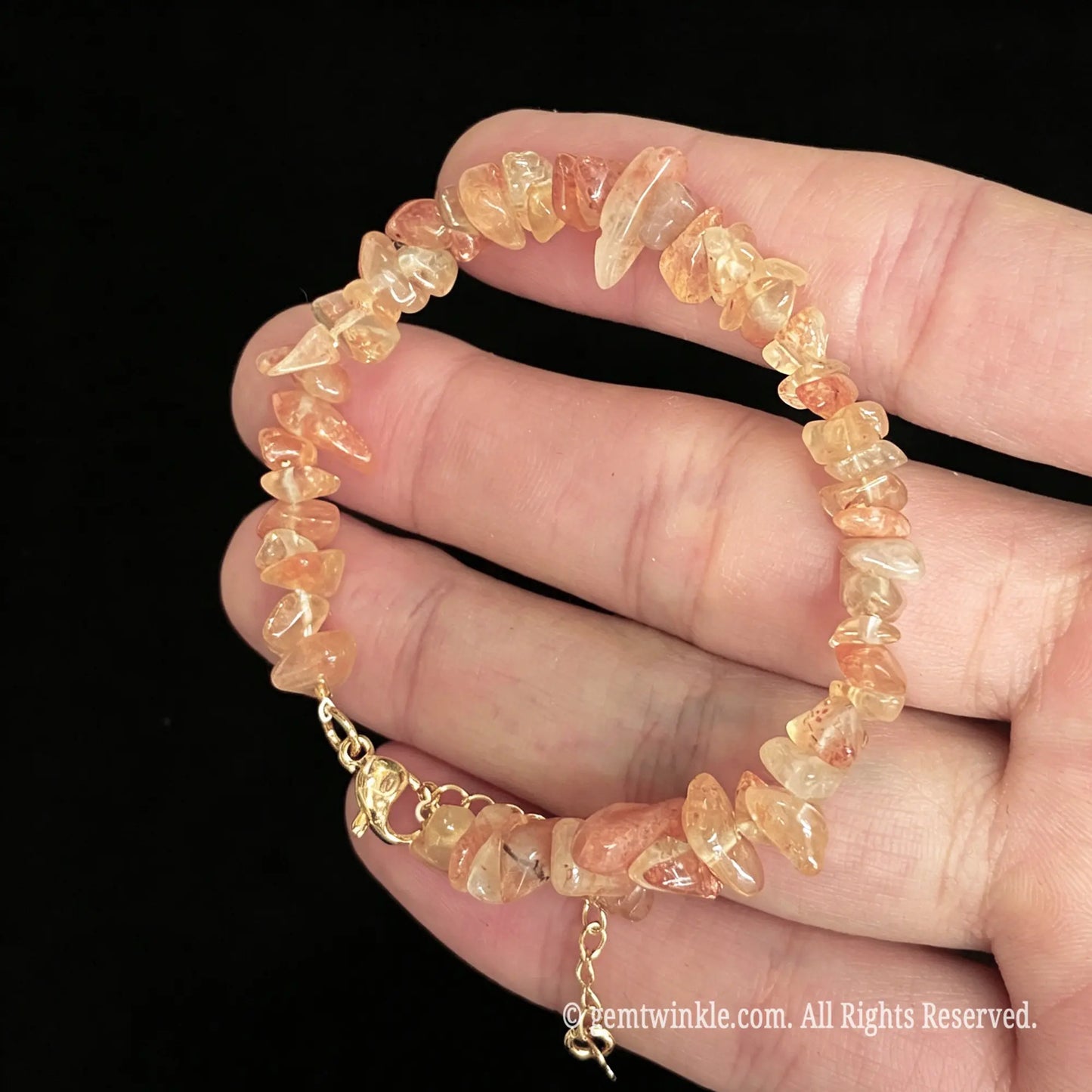 golden sunstone tumbled chip bracelet shown on hand displaying golden shimmer