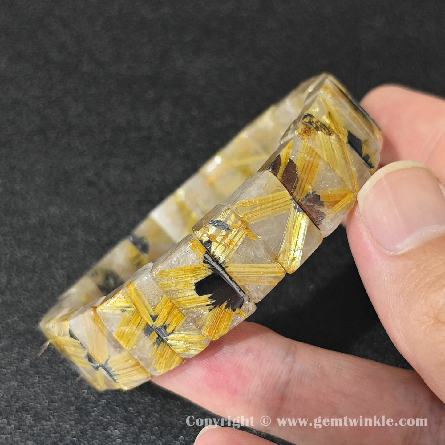 side profile view of machine polished golden rutilated quartz bangle bracelet