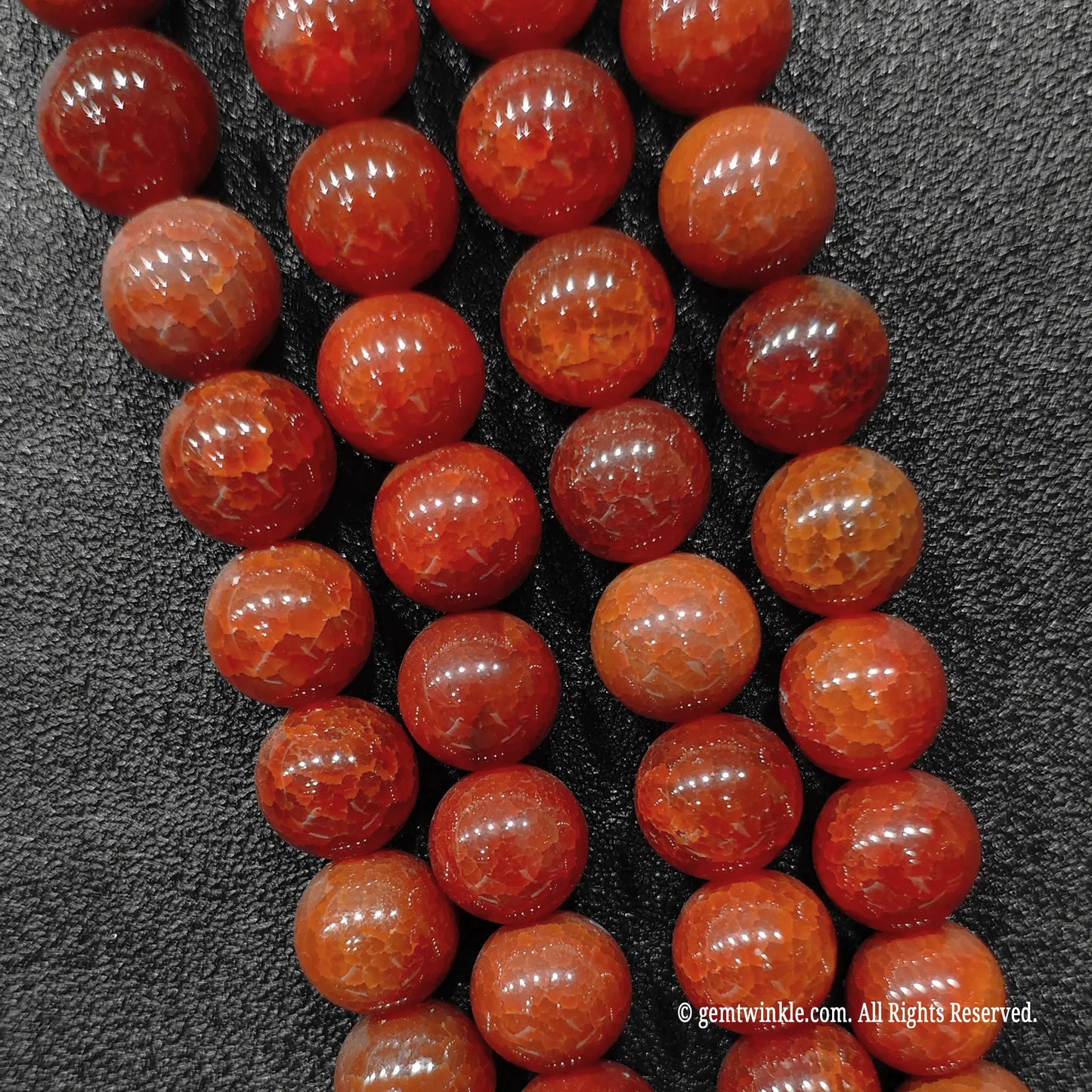 Close up view of gothic red dragon vein agate beads highlighting intense deep blood red coloration and fractured lines