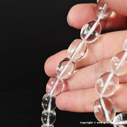 Premium double-A pure grade natural clear quartz nugget loose crystal beads strand with a mirror-smooth polish on a black background