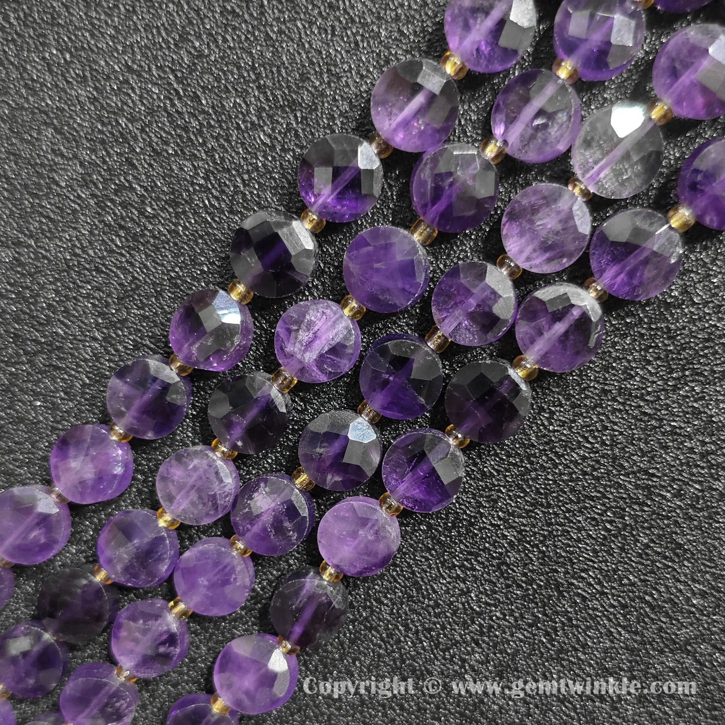 Close up view of Grade B amethyst faceted flat disc beads showing purple quartz