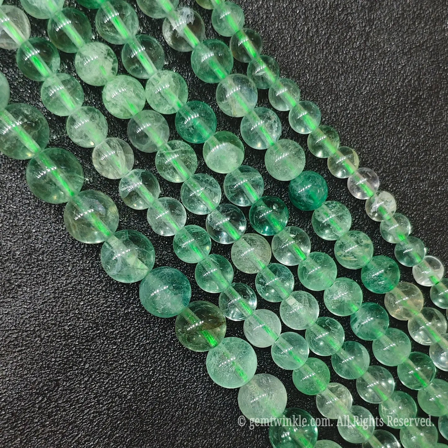 Affordable Grade B natural green fluorite loose gemstone strands from Donghai crystal market showing authentic organic wisps and character-rich textures