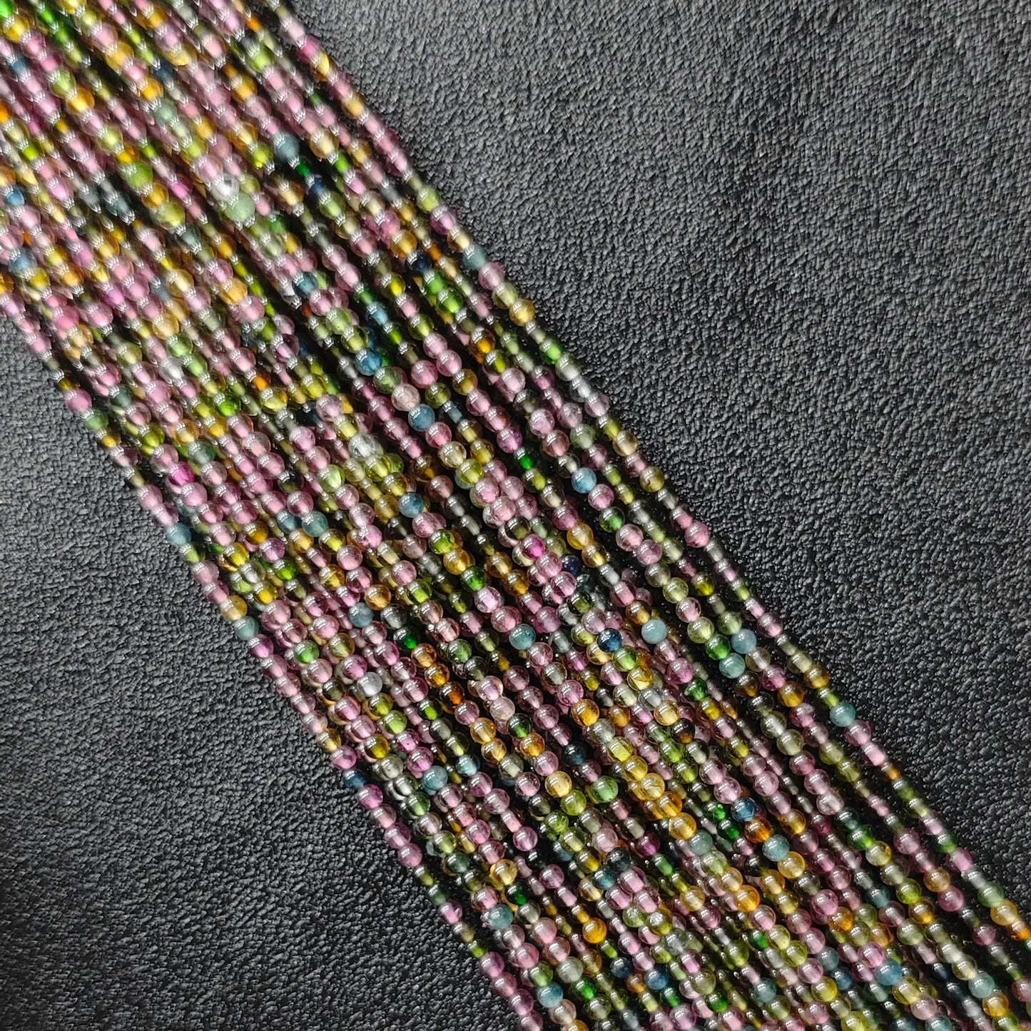 Grade B multi color tourmaline 2.5mm tiny gemstone beads macro close up view