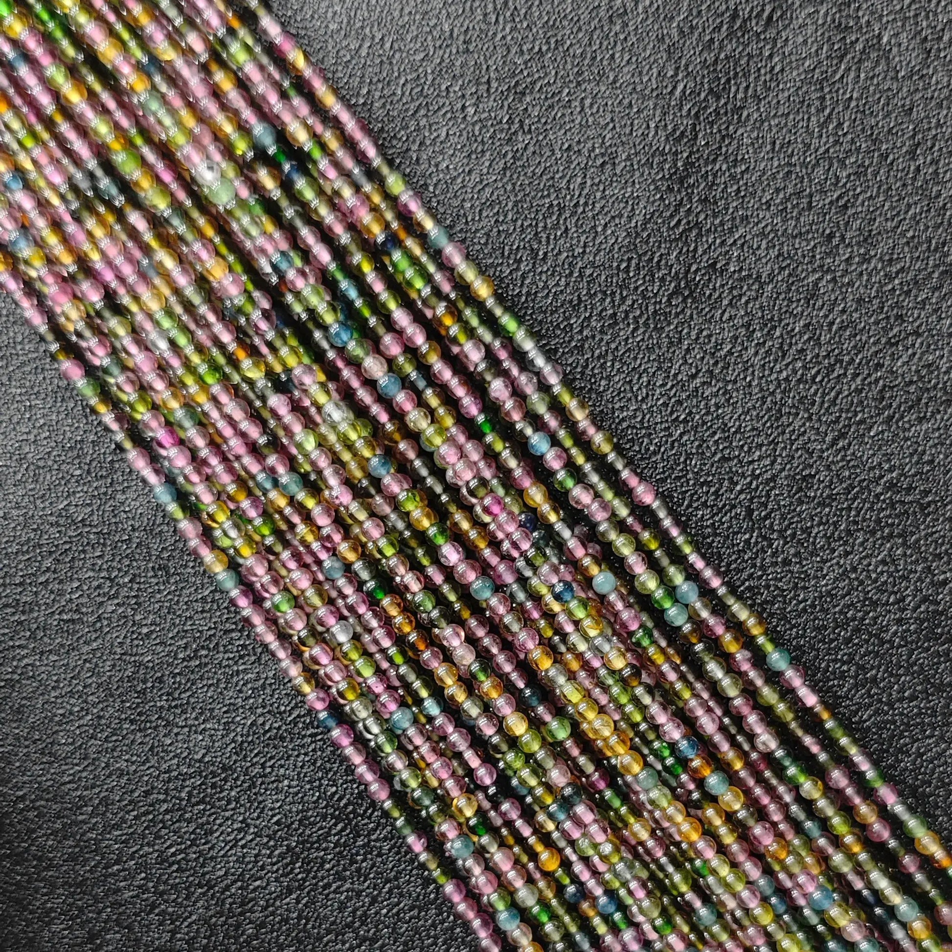Grade B multi color tourmaline 2.5mm tiny gemstone beads macro close up view