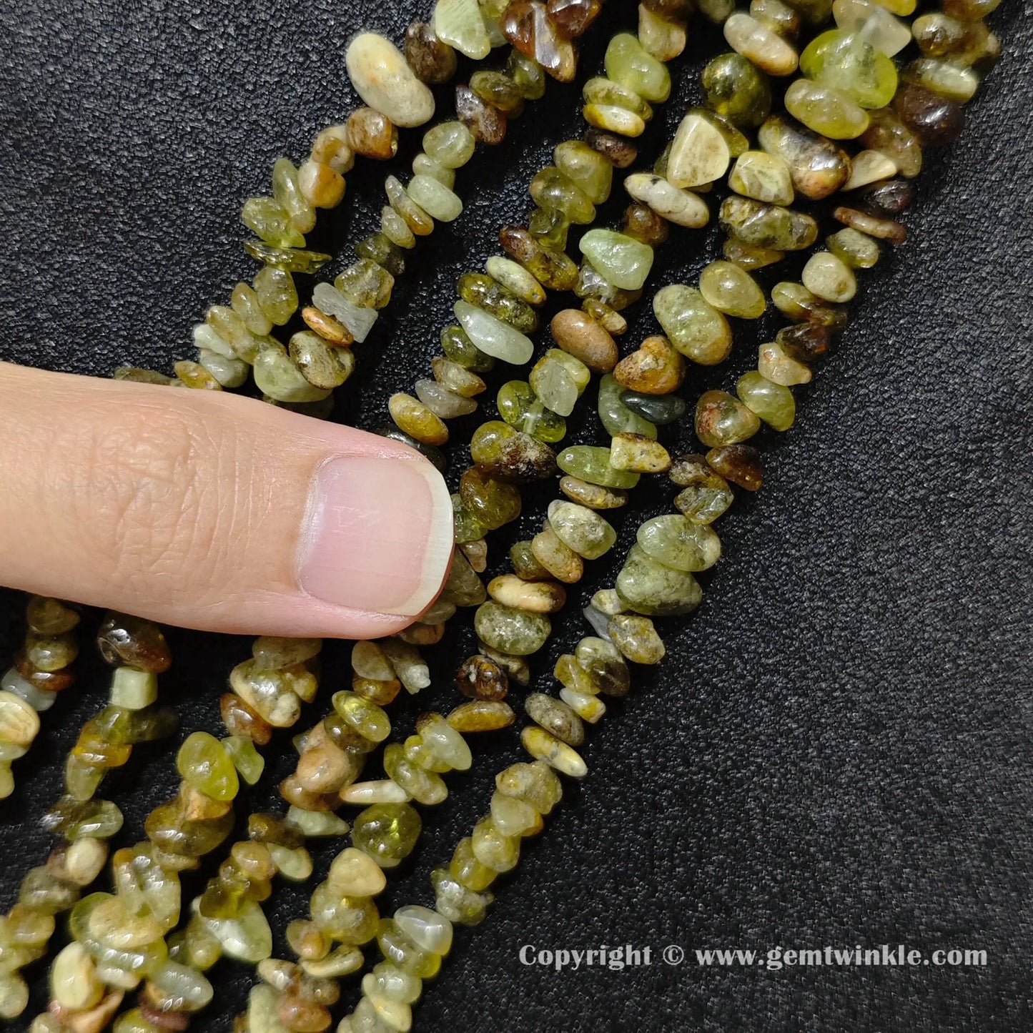 Close up view of natural green garnet chip beads demonstrating 80cm long strand yield