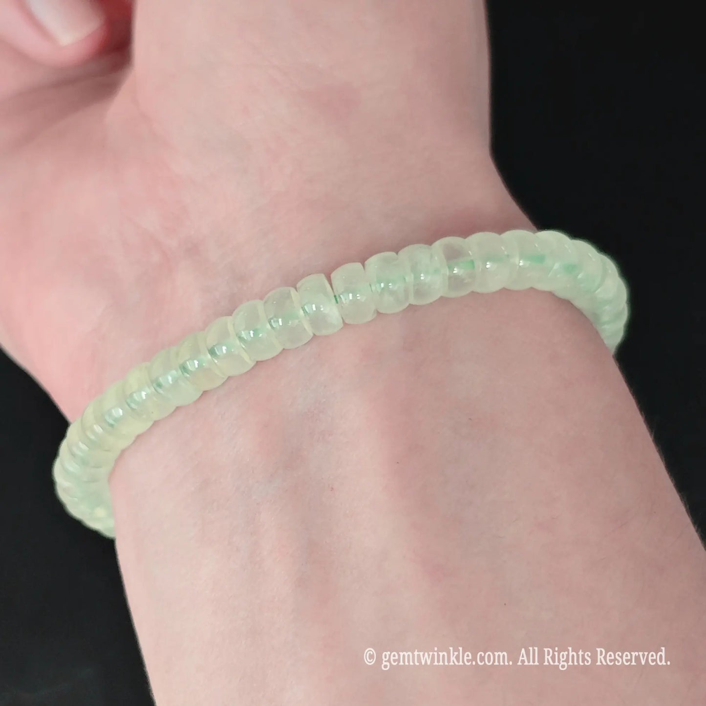 Full display view of green prehnite 5.5-6mm straight cut disc bead bracelet highlighting jelly translucency