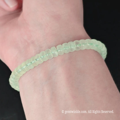 Full display view of green prehnite 5.5-6mm straight cut disc bead bracelet highlighting jelly translucency