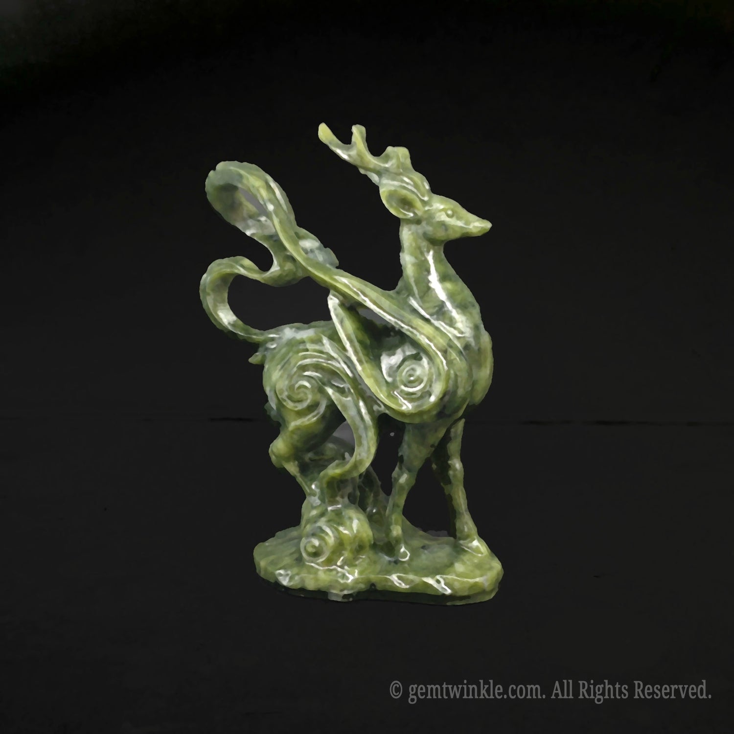Side view of a 10cm green serpentine stone mystical deer figurine showcasing detailed cloud scroll carvings on a black background