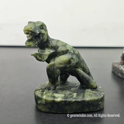 side profile view of green serpentine carved t-rex dinosaur figurine with open jaw and sturdy base