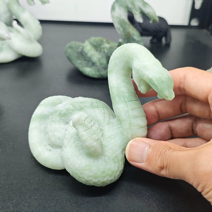 front view of natural green stone coiled cobra statue showing open mouth details and light green color