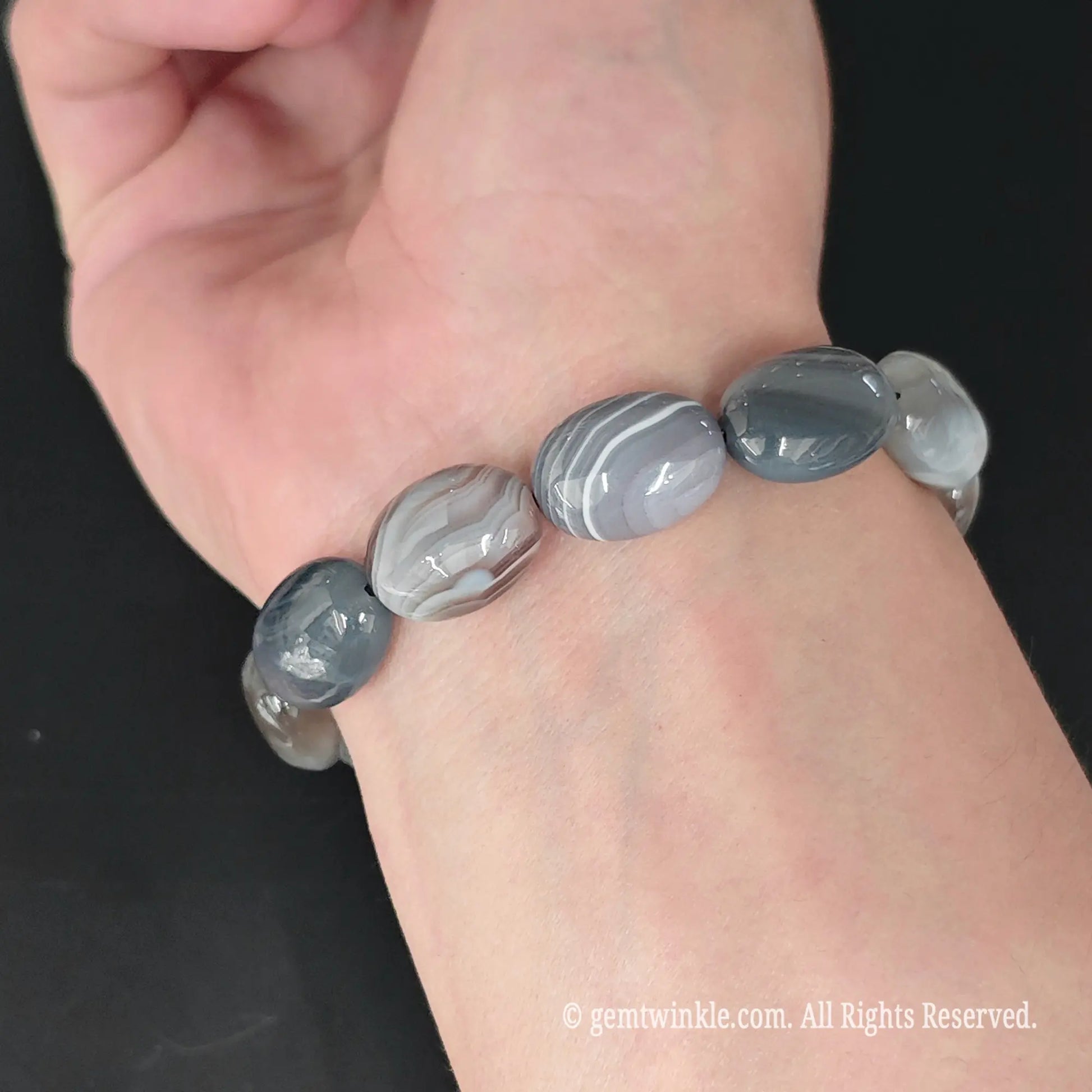 side view of natural grey persian agate barrel bead stretch bracelet on wrist