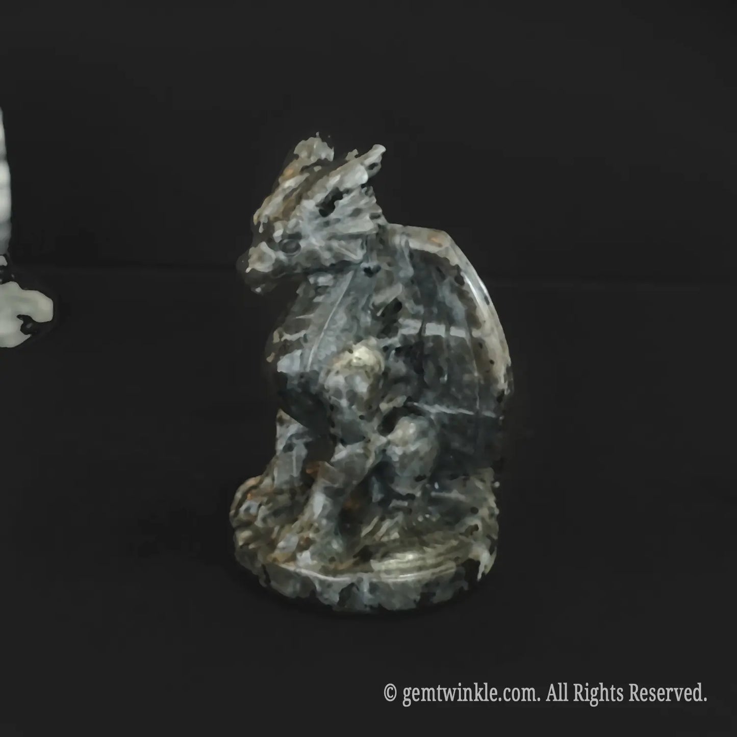 Grey spotted stone dragon figurine detailed view